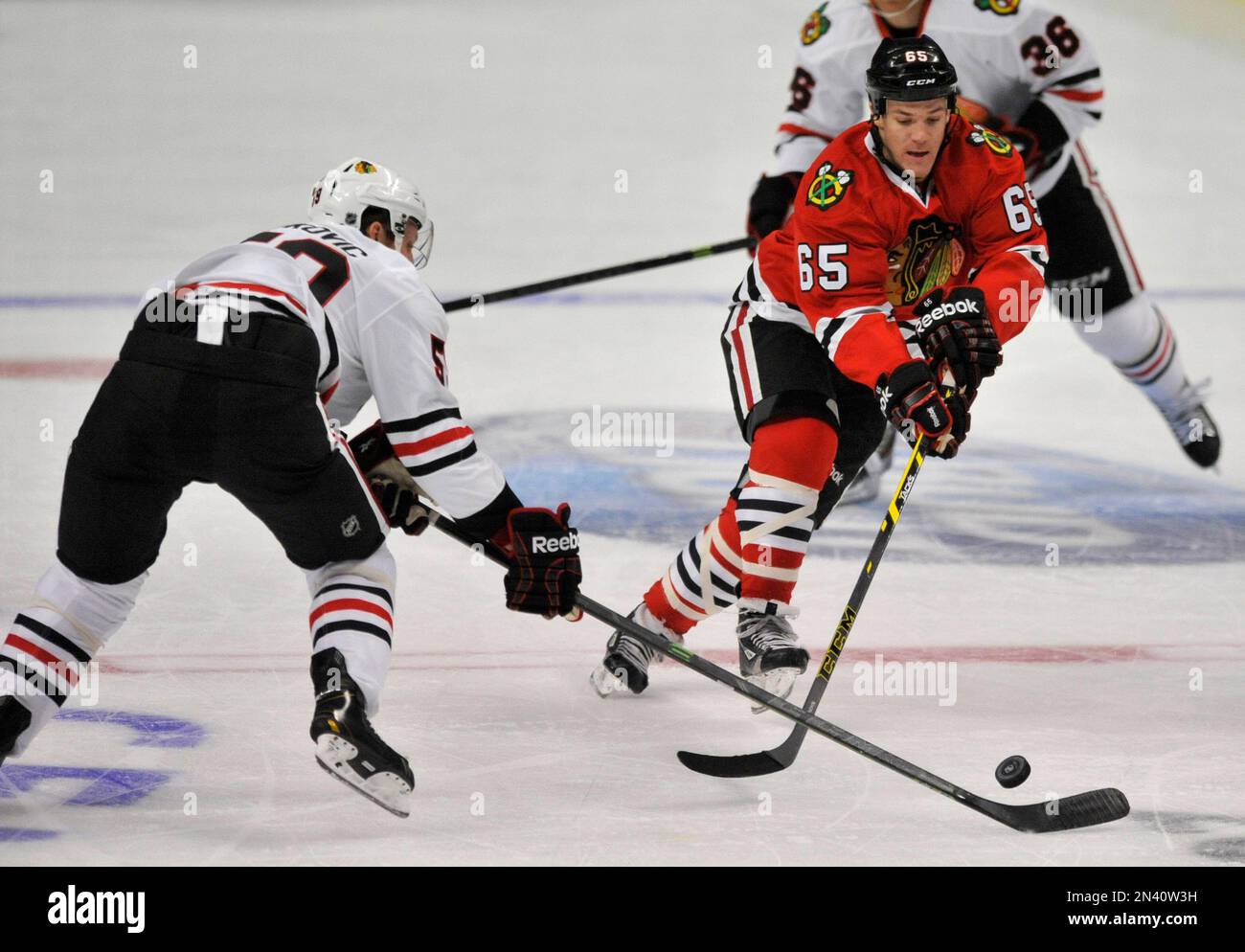Chicago Blackhawks' Andrew Shaw (65), battles Zach Miskovic (59), for