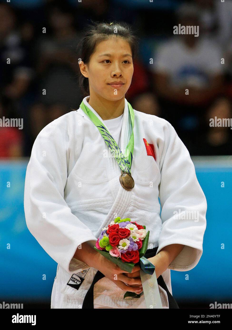 Bronze medallist China’s Zhang Zhehui stands for the medal ceremony for
