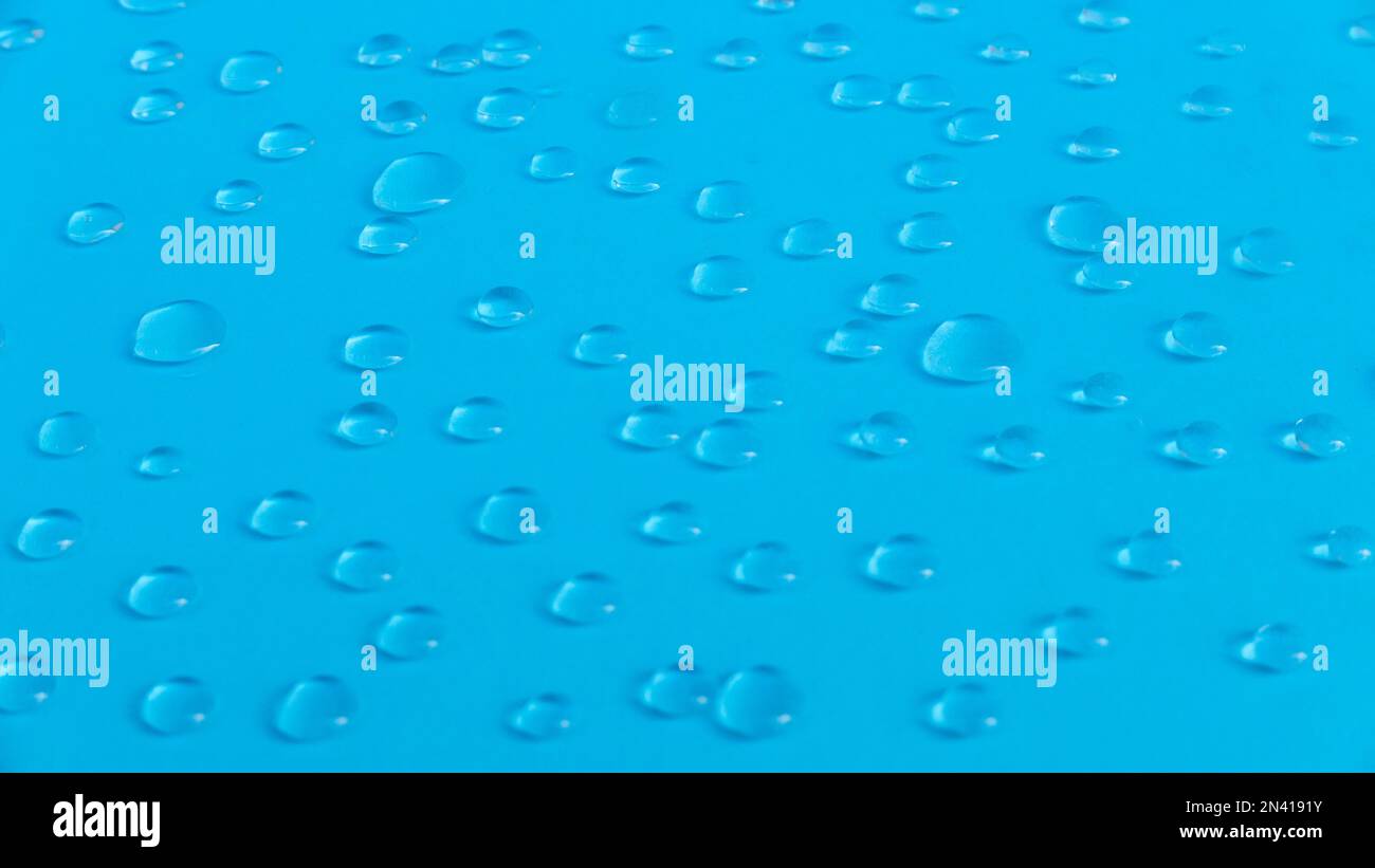 A water drop on a blue background. Stock Photo