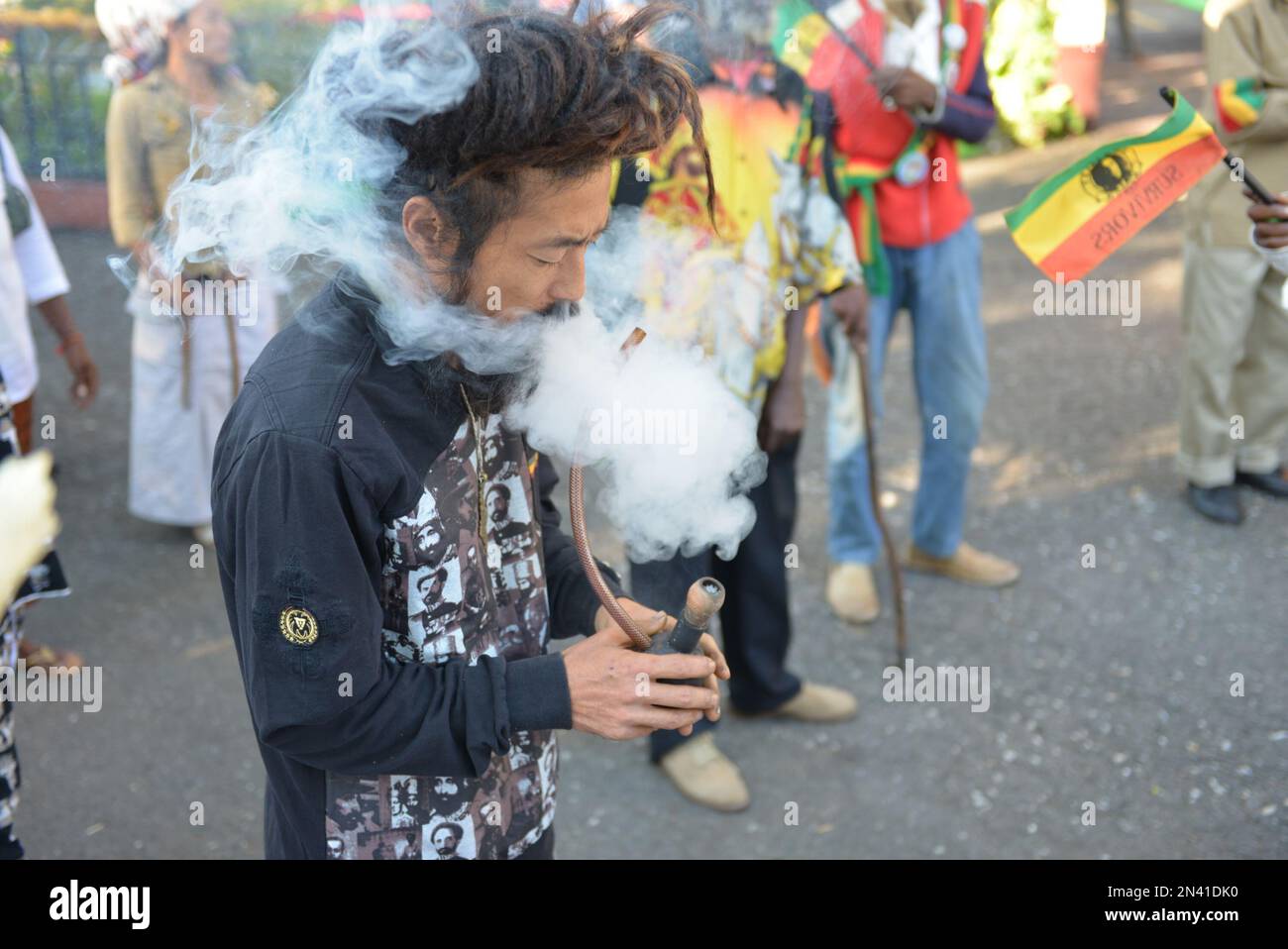 FILE - In this Feb. 6, 2013 photo, a Rastafarian named Bongho Jatusy smokes  a pipe of marijuana outside a museum dedicated to the memory of late reggae  icon Bob Marley in