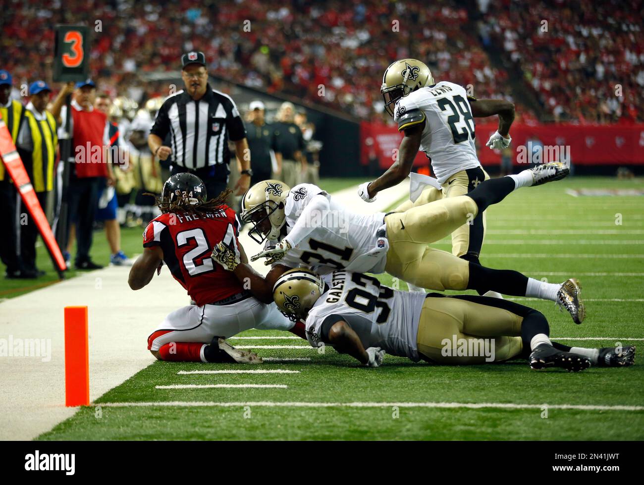 Atlanta Falcons running back Junior Coffey can go no farther. He is stopped  after a short gain by Billy Ray Smith (left), Dennis Gaubatz (53) and Fred  Miller (76) of the Baltimore