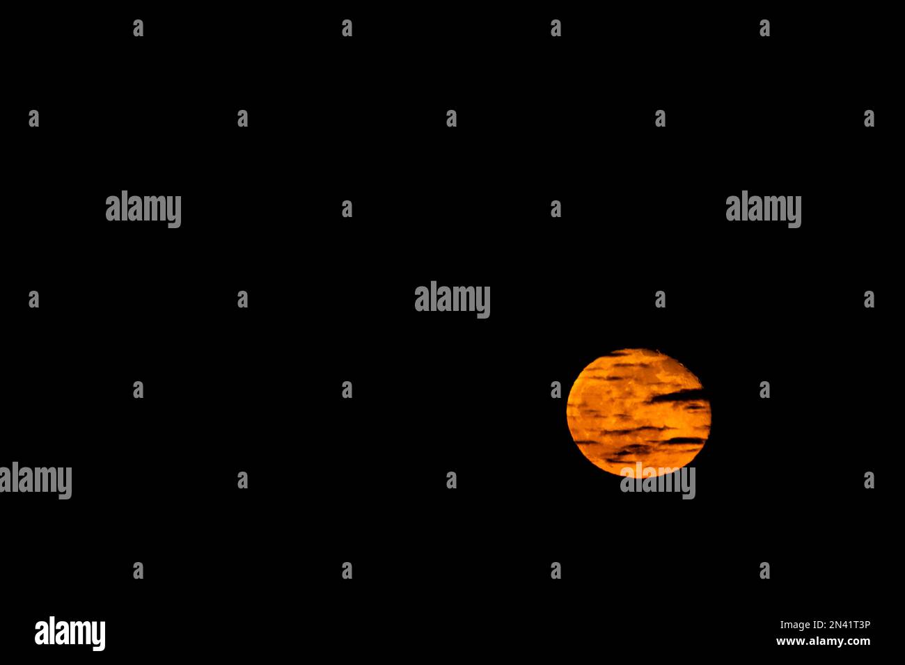 A 98% waning gibous moon, distorted and coloured red in the atmosphere