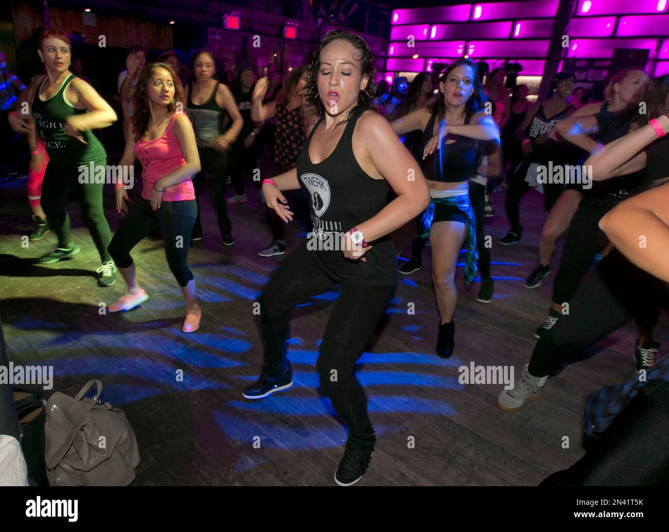 In this July 26, 2014 photo, Teena-Marie DiBartolo, center, and her mother,  Myra DiBartolo, far left, participate in a Vixen Workout fitness concert at  the Highline Ballroom, in New York, Saturday, July, image size:1300x1035