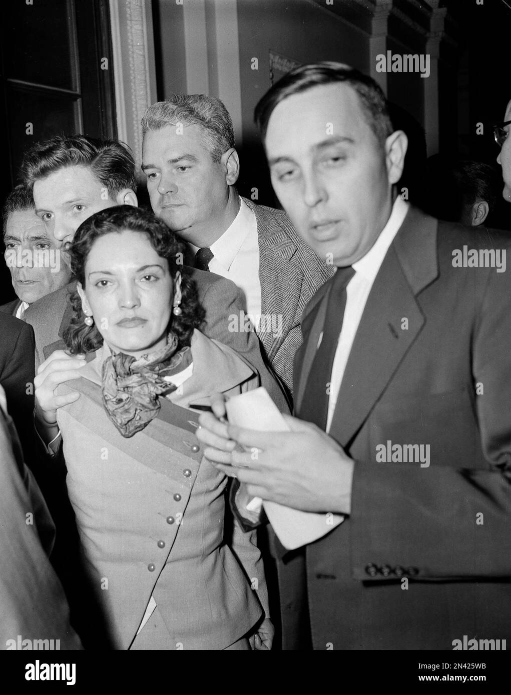 Puerto Rican nationalist, Lolita Lebron, is hustled through the crowd after  she was involved in a shooting attack on Capitol Hill, March 1, 1954 .  While shouting "Free Puerto Rico," a commando