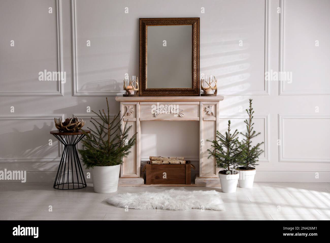 Beautiful room interior with potted fir trees and fireplace Stock Photo ...