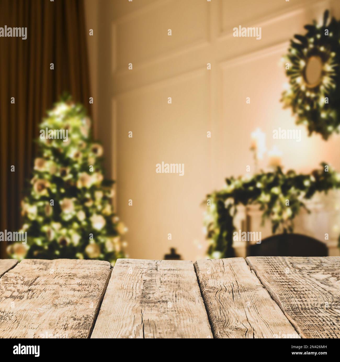 Empty wooden surface and blurred view of Christmas tree in room, space ...