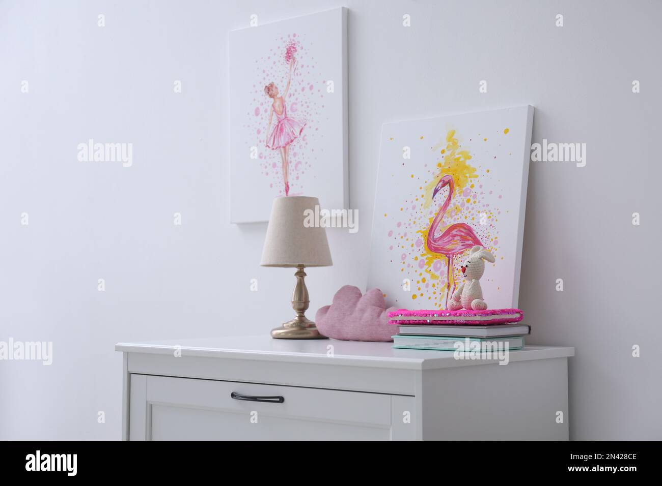 Chest of drawers and beautiful pictures in children's room. Interior design Stock Photo