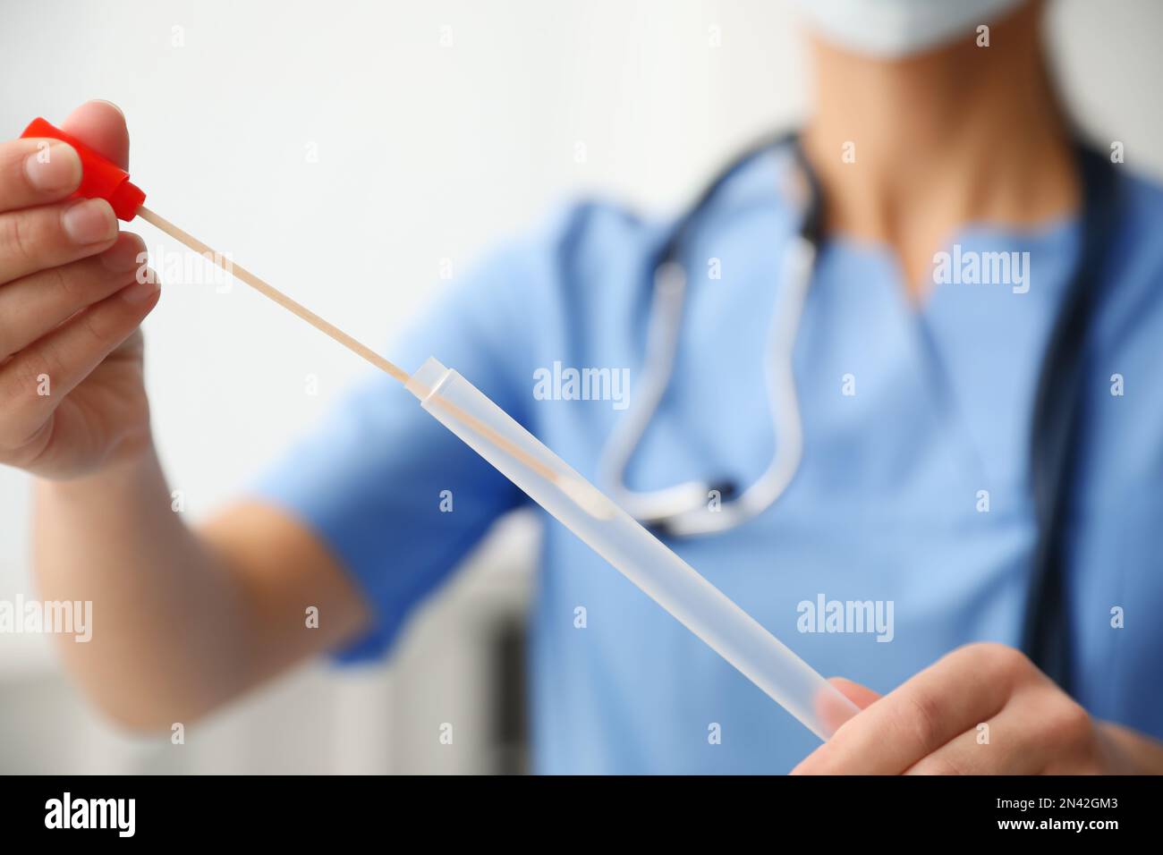 Doctor holding buccal cotton swab and tube for DNA test in clinic, closeup Stock Photo Alamy