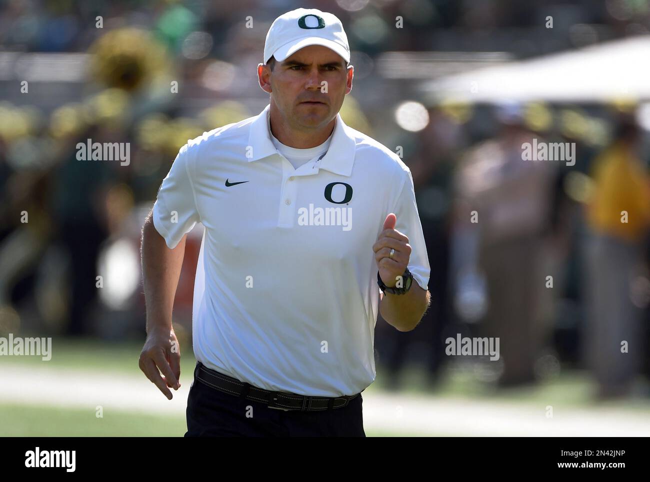 Oregon head coach Mark Helfrich runs off the field after warm ups