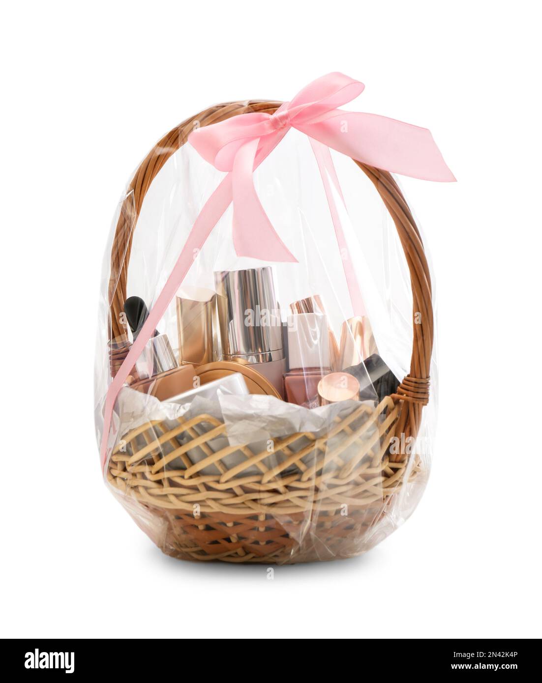 Wicker gift basket with cosmetic products isolated on white Stock Photo