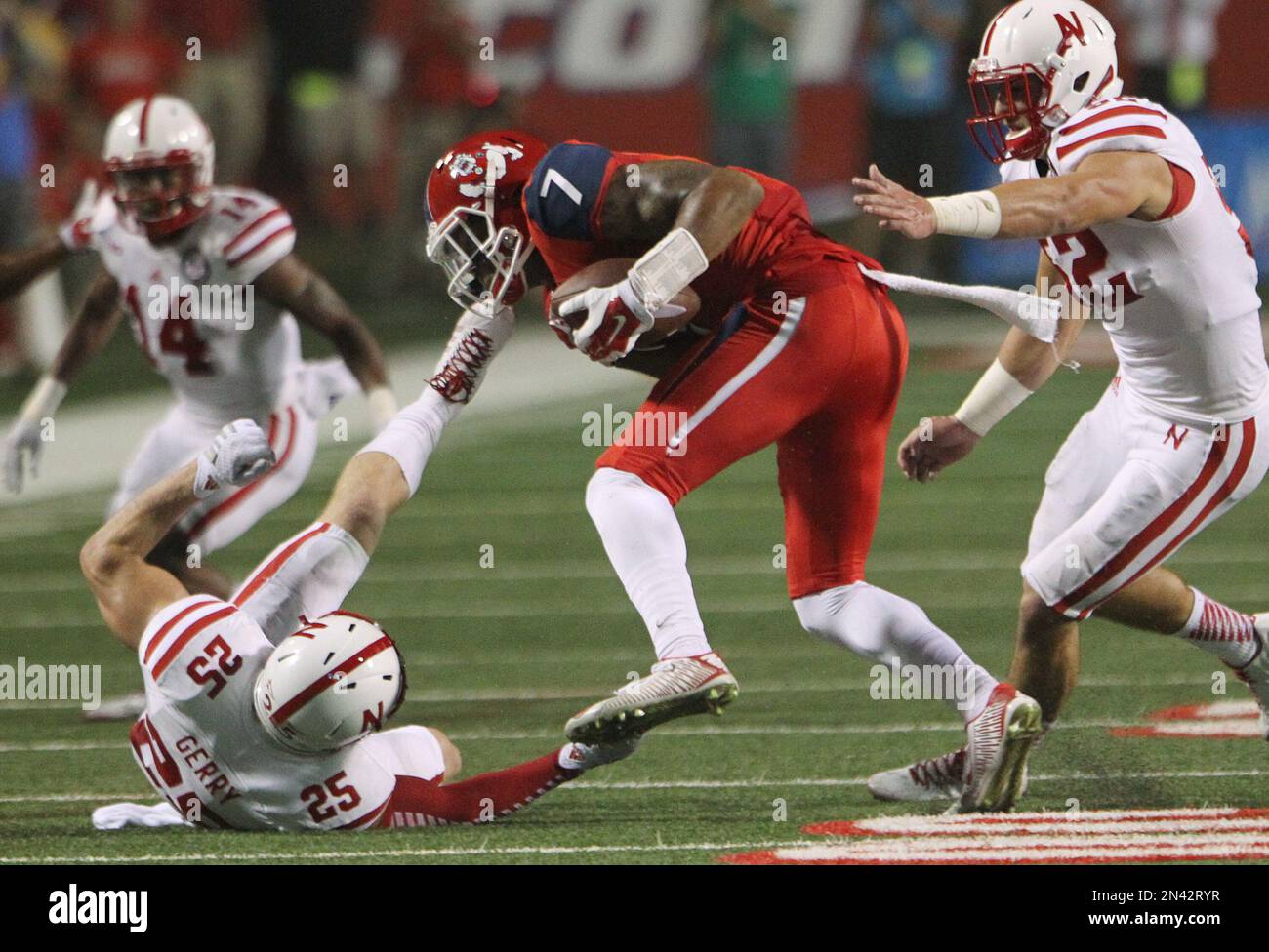 Fresno State's Aaron Peck is brought down by Nebraska's Nate Gerry ...