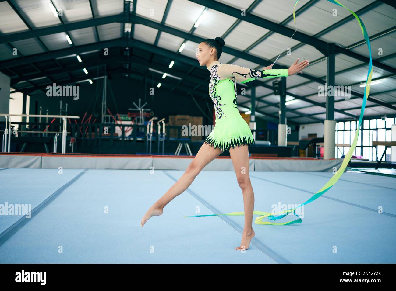 Rhythmic gymnastics, fitness and woman in gym with ribbon, sport and