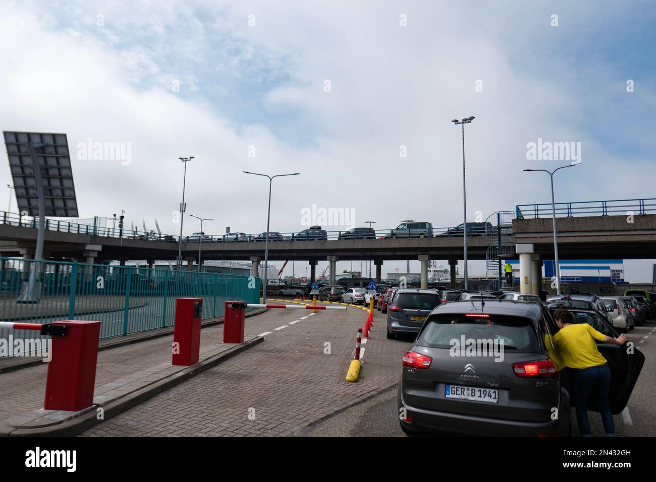 Cars waiting in a queue to get aboard ferry boat in the TESO Ferry Port in Den Helder, The Netherlands with destination Texel island Stock Photo