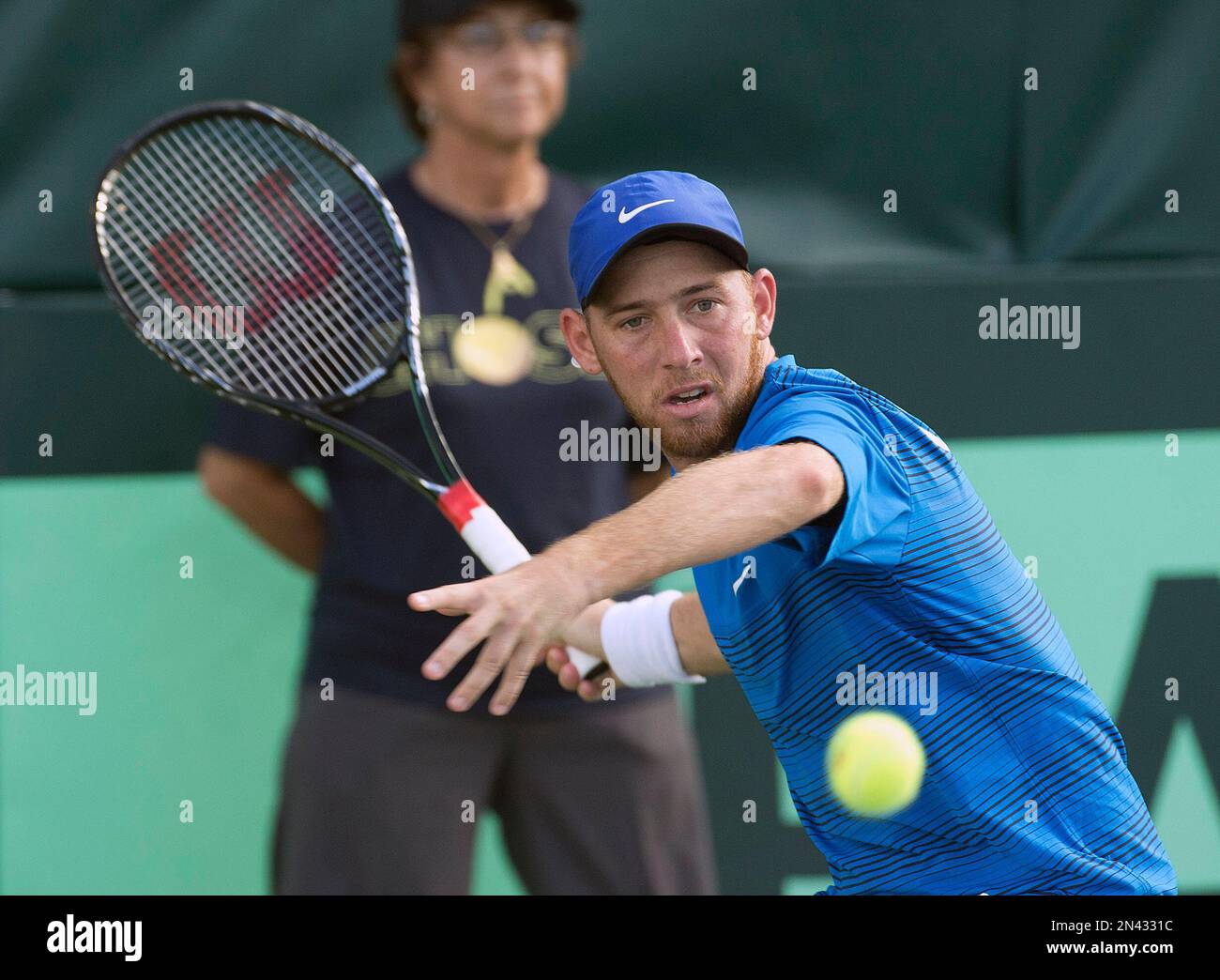 Dudi Sela, of Israel, eyes the ball before returning to Carlos Berlocq ...