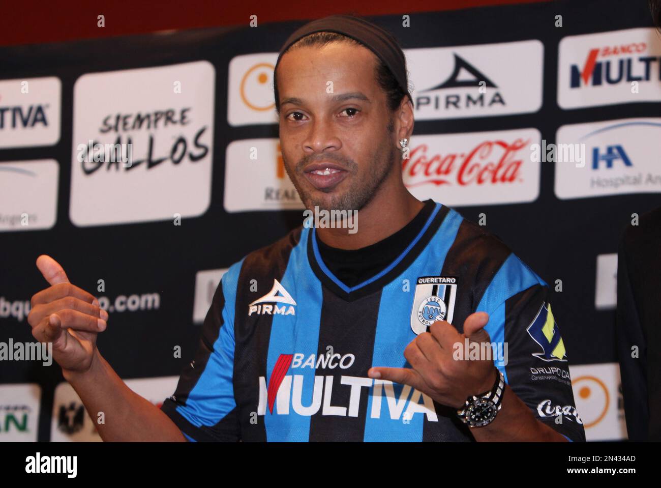Brazil's Ronaldinho dons his new Queretaro soccer club jersey at a press  conference in Mexico City, Friday, Sept. 12, 2014. Mexican first-division  club Queretaro signed the former 34-year-old Brazil star, who had