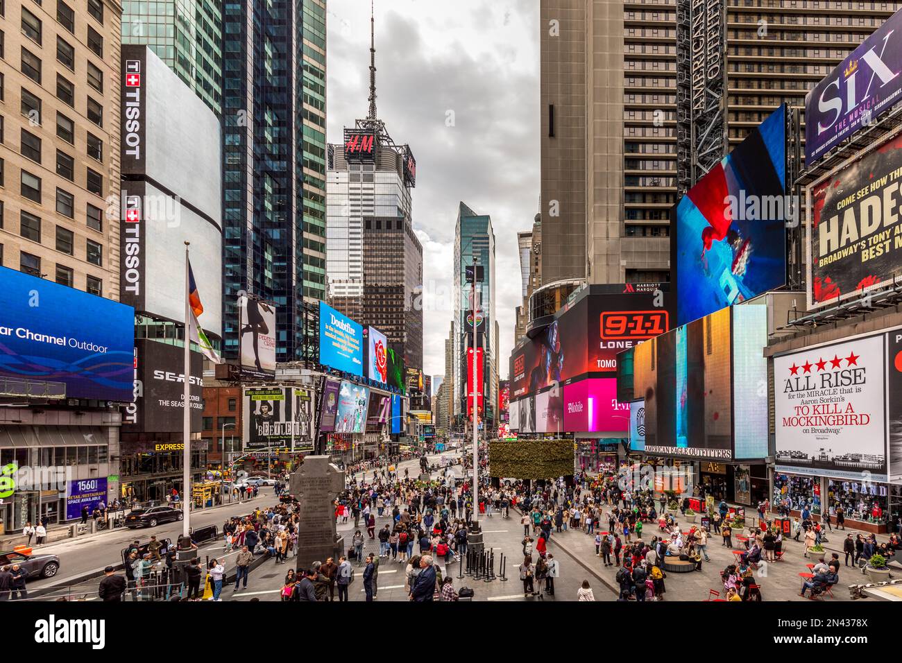 New York, USA - April 24, 2022: Times Square with tourists. Iconified as 'The Crossroads of the World' it's the brightly illuminated hub of the Broadw Stock Photo