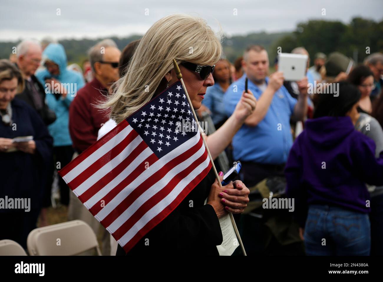 Visitors to the Flight 93 National Memorial in Shanksville, Pa.. listen