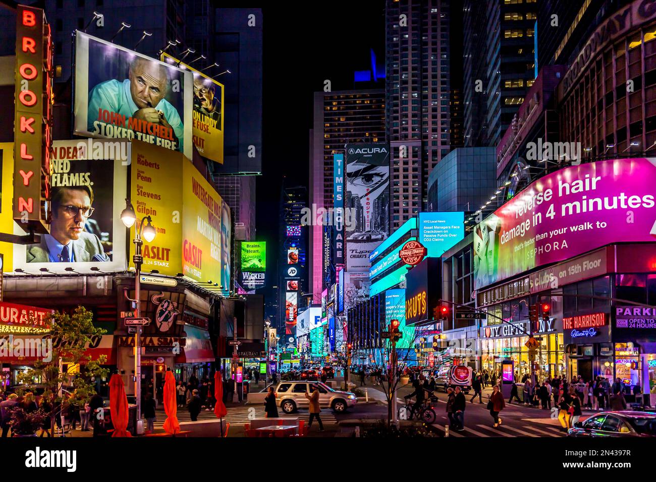 New York, USA - April 24, 2022: Times Square with tourists. Iconified as "The Crossroads of the World" it's the brightly illuminated hub of the Broadw Stock Photo