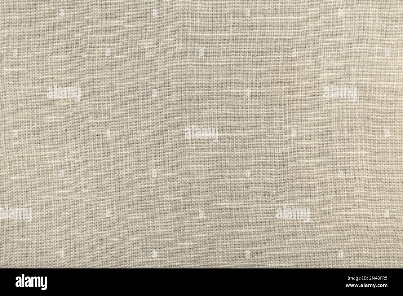 finely textured background of beige linen fabric. Stock Photo