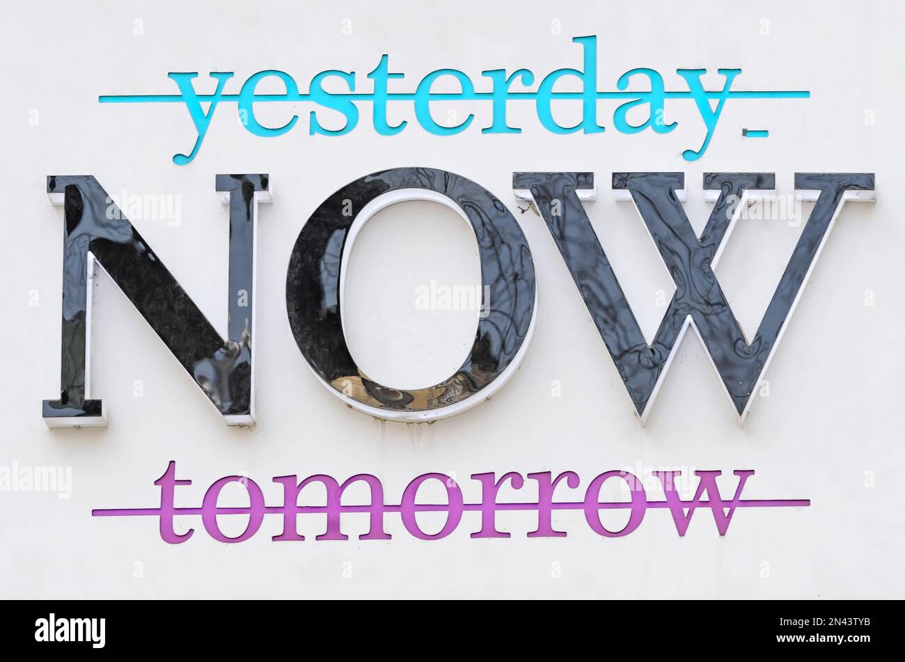 Crossed out words yesterday and tomorrow banner praising the moment of