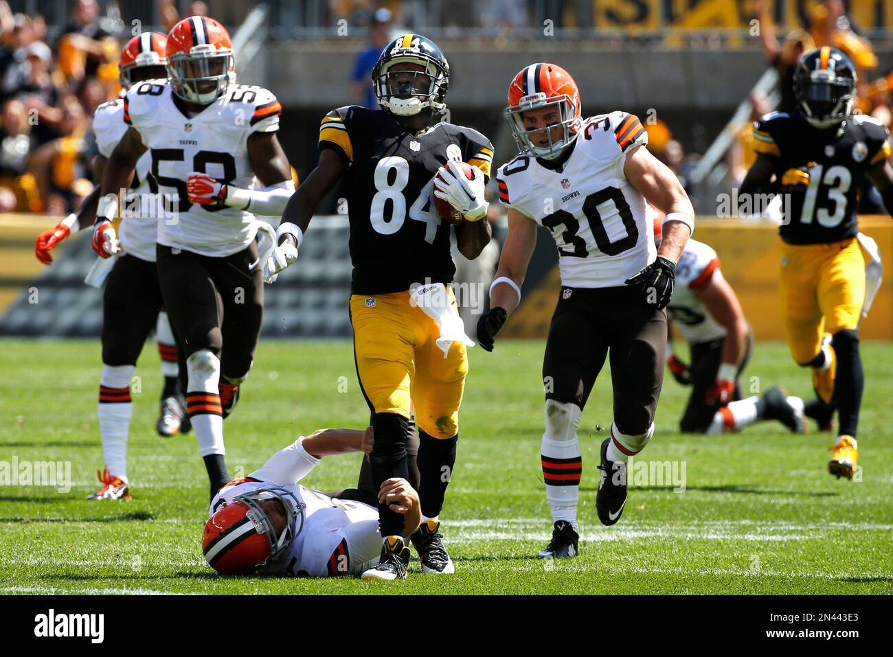 Pittsburgh Steelers Antonio Brown (84) kicks Cleveland Browns punter  Spencer Lanning (5) as he jumps while returning a punt in the second  quarter of the NFL football game on Sunday, Sept. 7,