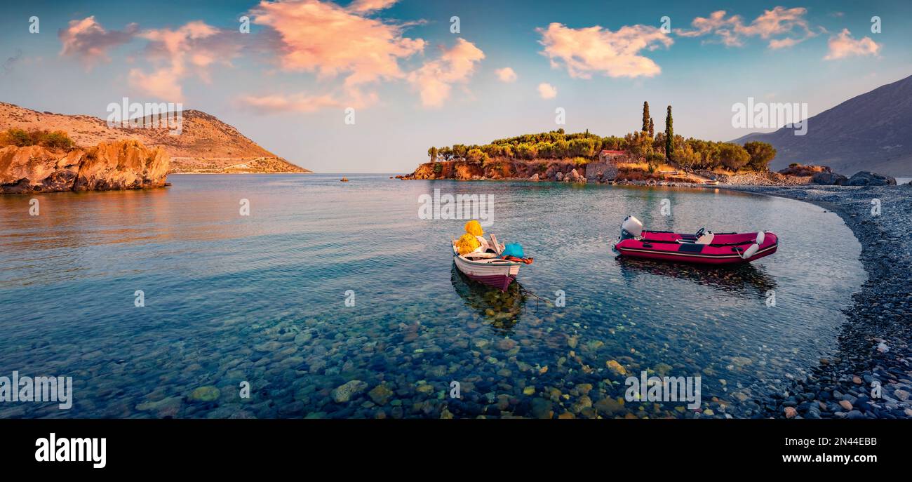 Adorable summer view of Purpose or Double beach with two fishing boats, Kotronas town location. Calm sunset on Mediterranean sea, Peloponnese peninsul Stock Photo