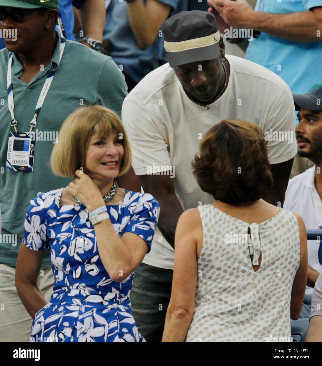 Anna Wintour, left, editor-in-chief of American Vogue, and former  basketball player Michael Jordan, talk with other spectators before  watching play between Roger Federer, of Switzerland, and Marin Cilic, of  Croatia, during the