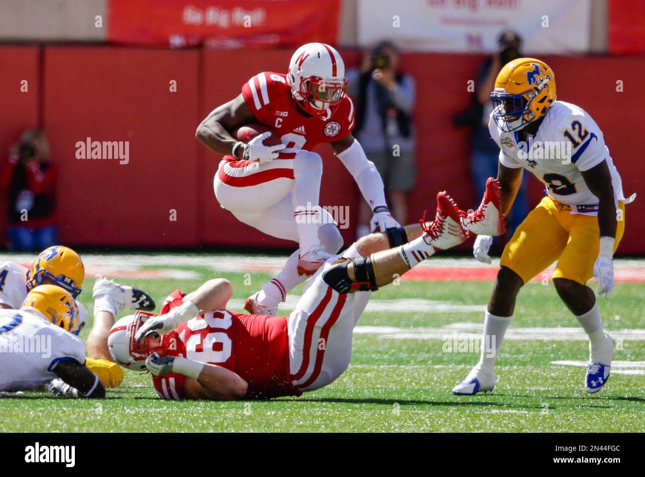 Nebraska running back Ameer Abdullah (8) vaults Nebraska offensive
