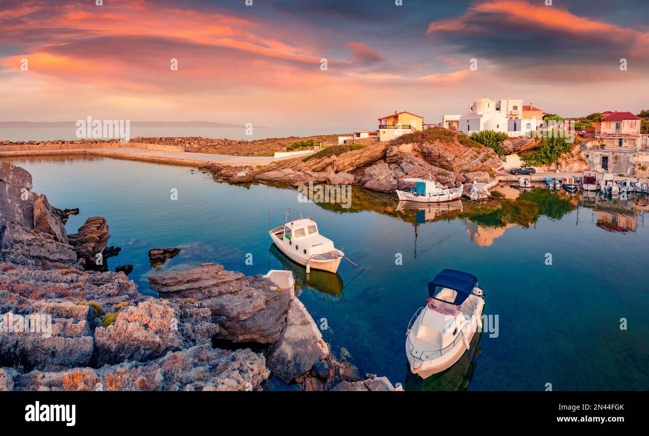Beautiful sunrise in Vathi port. Attractive summer scene of Peloponnese peninsula, Greece, Europe. Wonderful morning seascape of Mediterranean sea. Tr Stock Photo