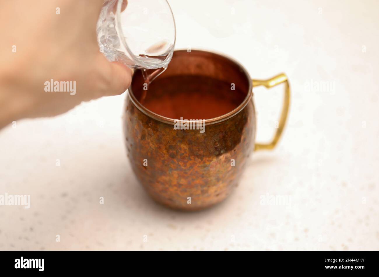 Making alcohol drink with shot glass in cup Stock Photo Alamy