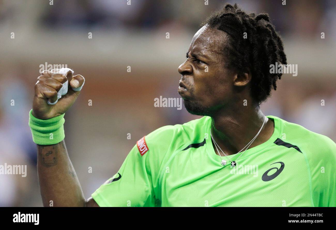 Gael Monfils, of France, pumps his fist after winning a point against Roger  Federer, of Switzerland, during the quarterfinals of the U.S. Open tennis  tournament, Thursday, Sept. 4, 2014, in New York. (