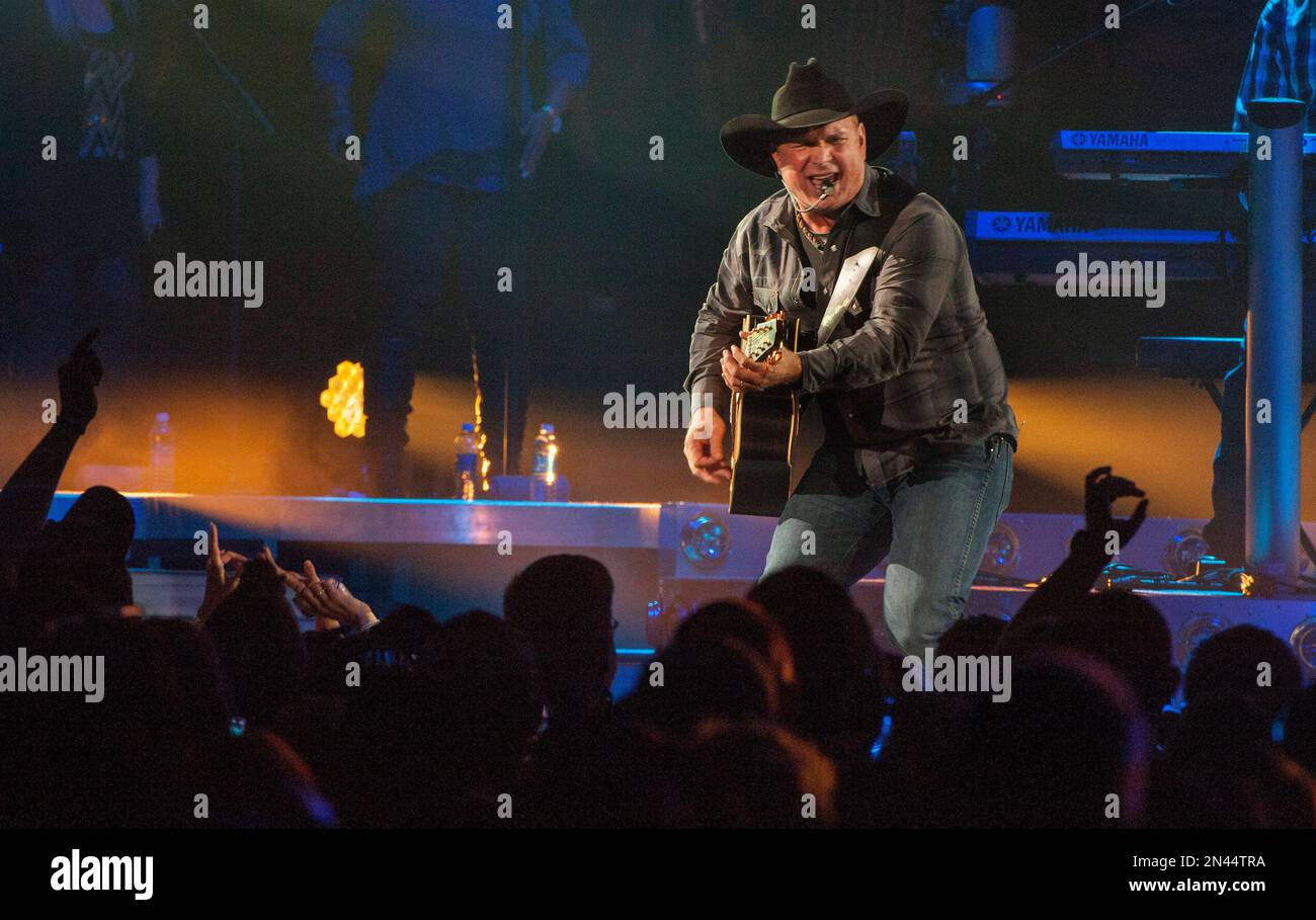 Country music star Garth Brooks, center wearing black cowboy hat
