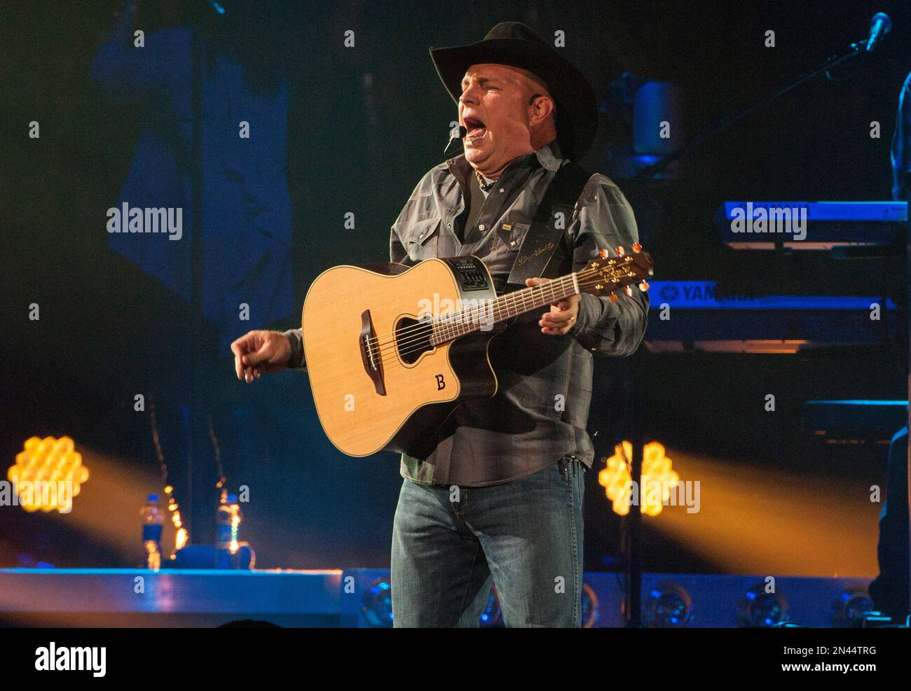 Country music star Garth Brooks, center wearing black cowboy hat