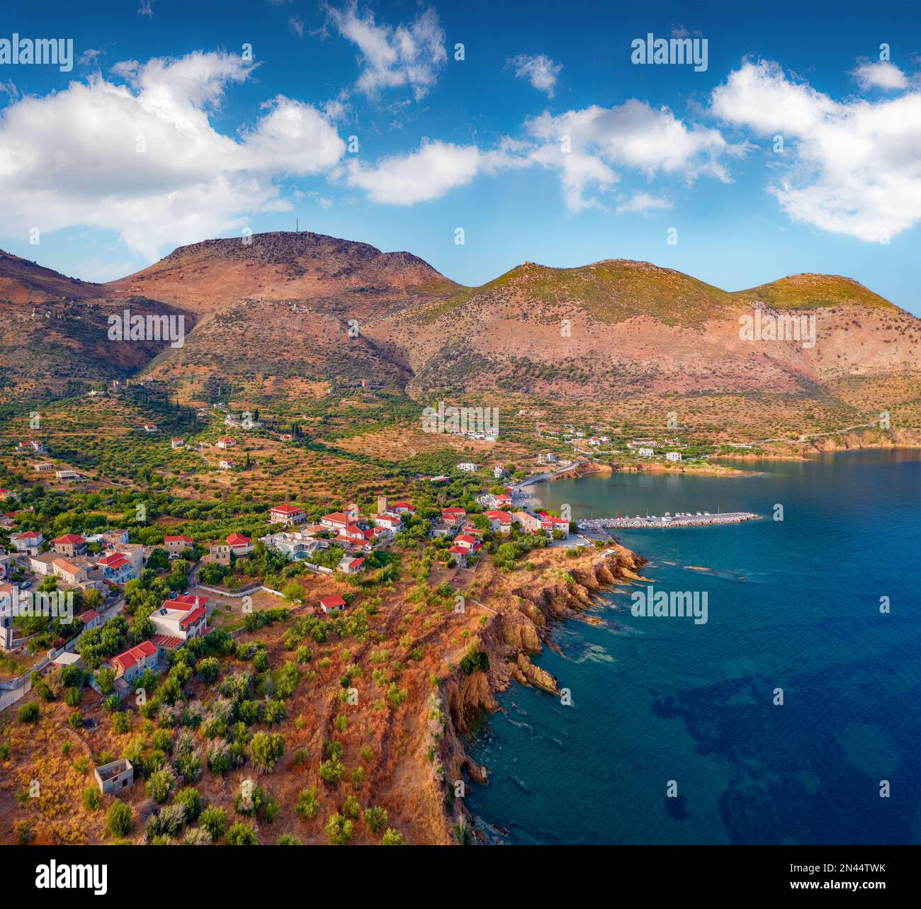 View from flying drone of Kotronas village. Picturesque evening seascape of Mediterranean sea. Beautiful outdoor scene of Peloponnese peninsula, Greec Stock Photo
