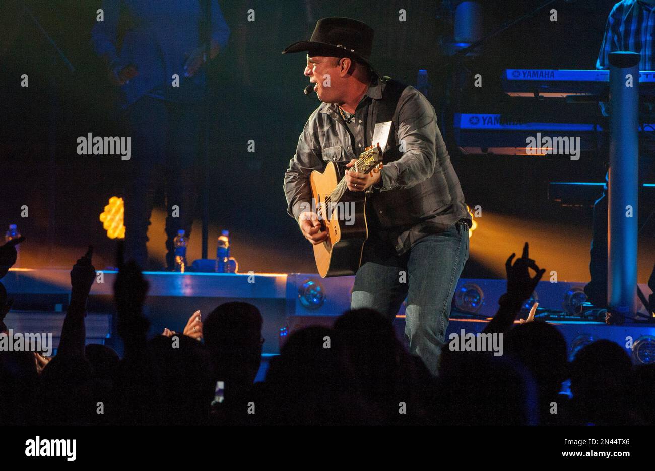 Country music star Garth Brooks, center wearing black cowboy hat