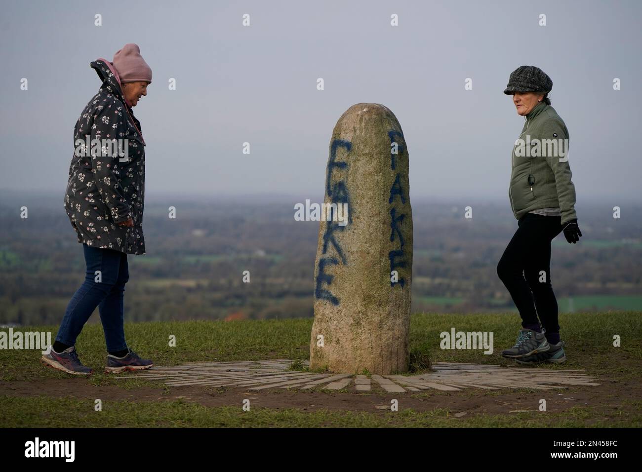Members of the public look at graffiti on the Lia Fail standing stone, which is also known as the Stone of Destiny, on the Hill of Tara near Skryne in County Meath. Picture date: Wednesday February 8, 2023. Stock Photo
