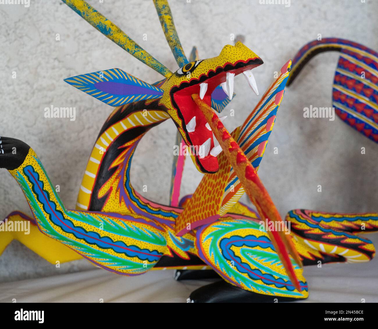 A fire-breathing alebrije dragon in an artisan's shop / workshop in San Antonio Arrazola, Oaxaca, Mexico. Alebrijes are colorful painted creatures re Stock Photo