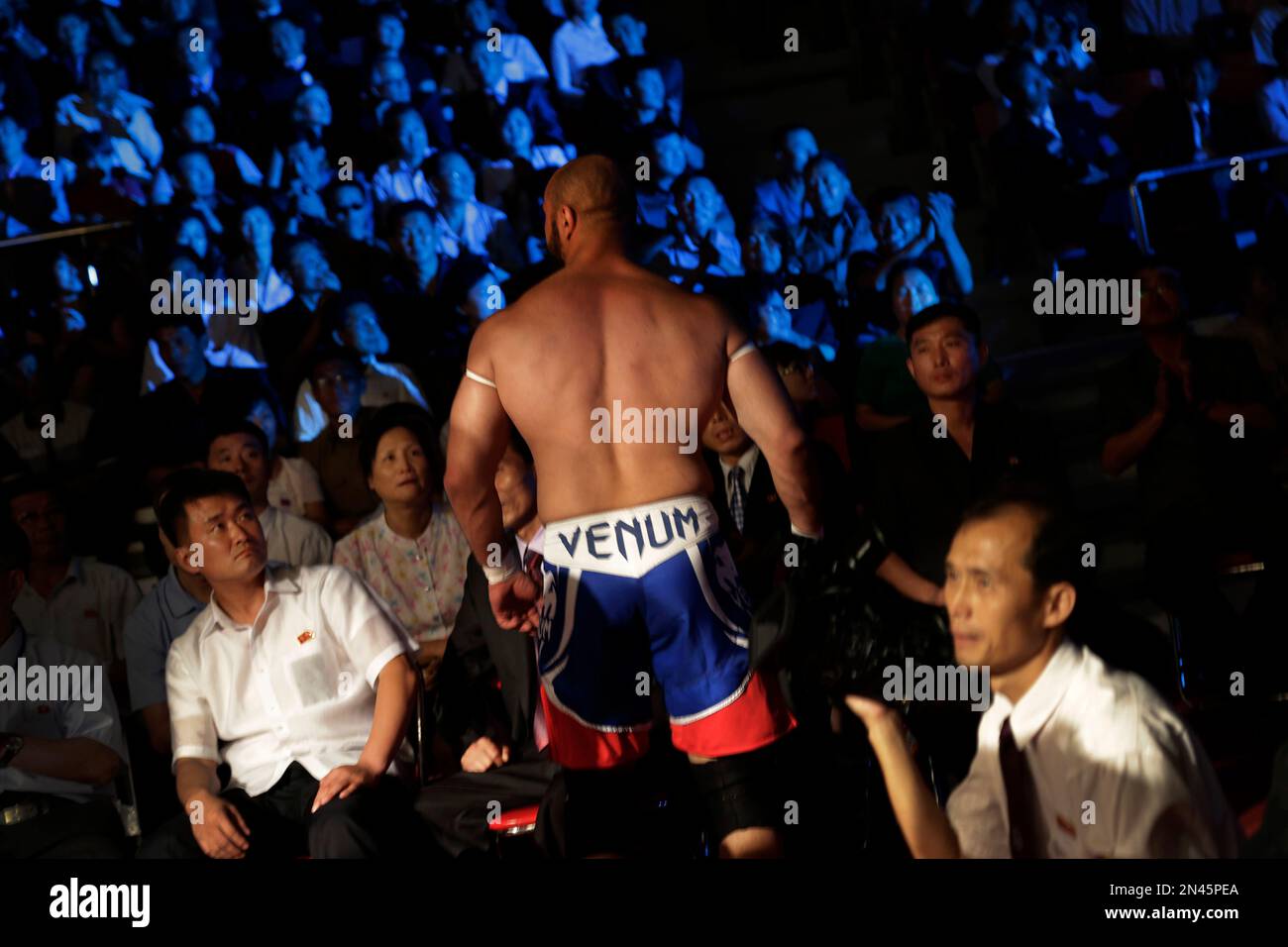 North Koreans watch a prowrestler leave the fighting arena after a