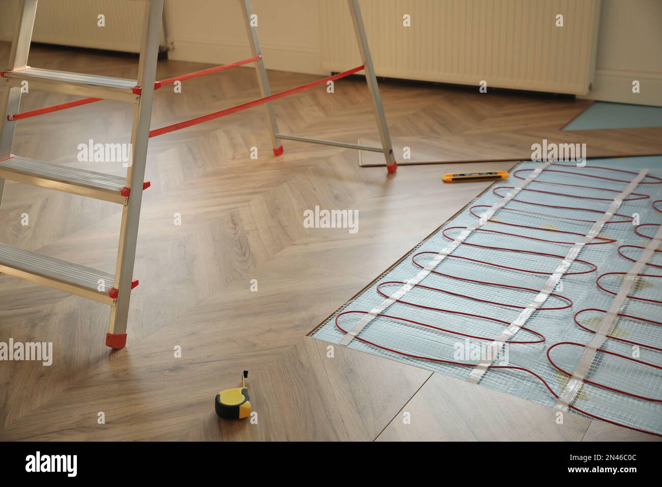 Installation of electric underfloor heating system indoors Stock Photo