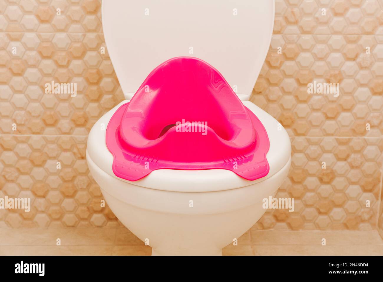 Baby pink toilet seat in toilet. Hygiene. Children's toilet. Children's