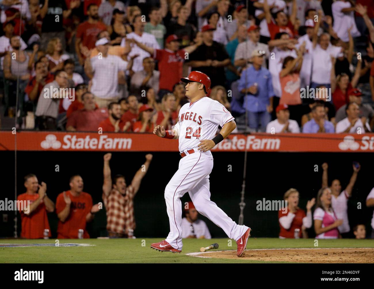 Los Angeles Angels' Hank Conger scores on double by Mike Trout during the fourth inning of a