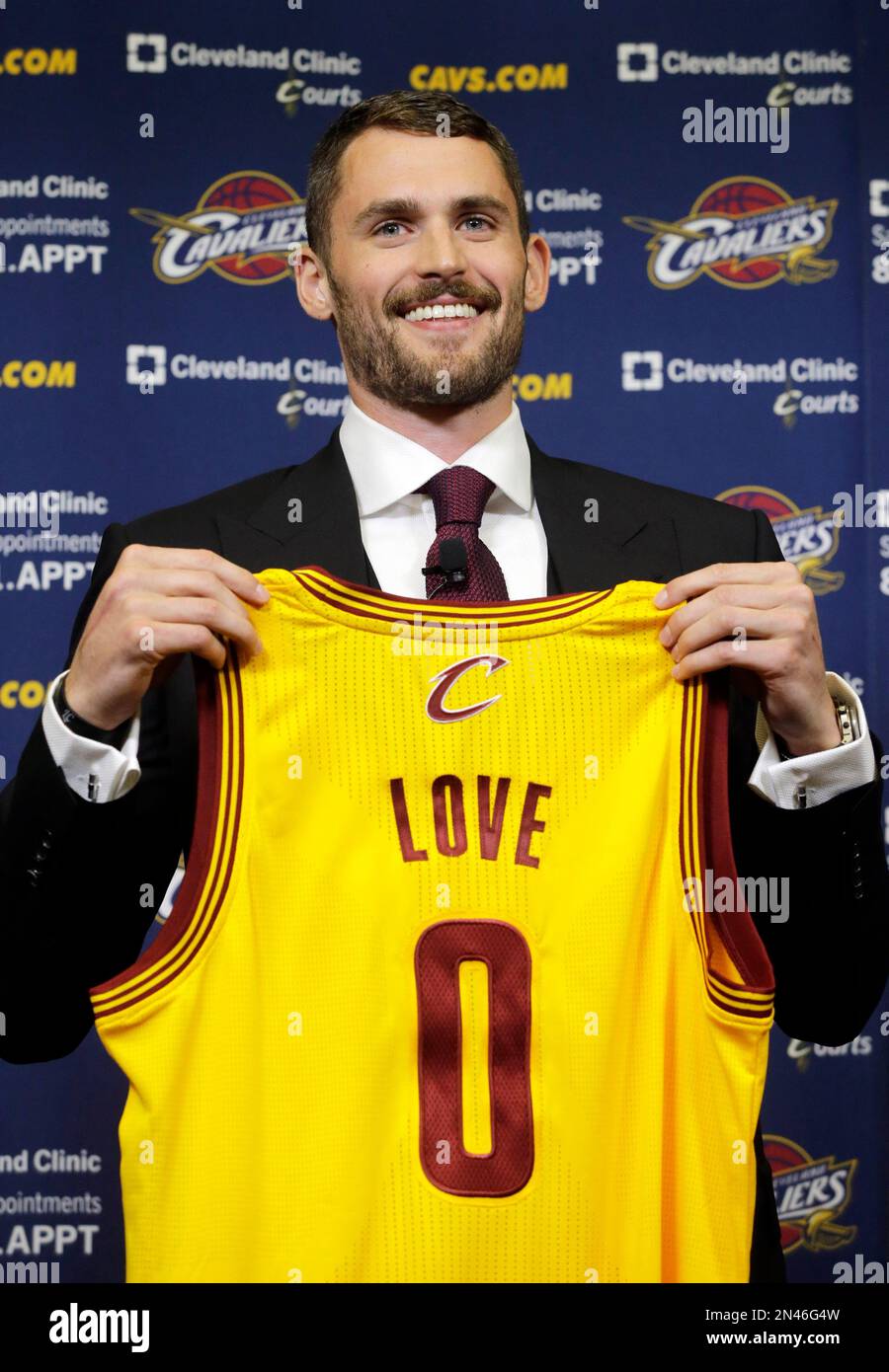 Kevin Love holds his new Cleveland Cavaliers jersey at the NBA basketball  team's practice facility in Independence, Ohio Tuesday, Aug. 26, 2014. Love  was acquired from the Minnesota Timberwolves in a three-team