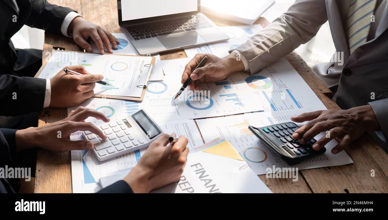 Business team analyzing income charts and graphs with modern laptop ...