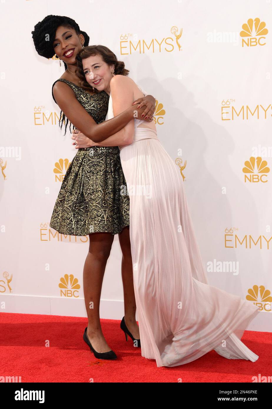 Jessica Williams, left, and Kristen Schaal arrive at the 66th Primetime  Emmy Awards at the Nokia Theatre L.A. Live on Monday, Aug. 25, 2014, in Los  Angeles. (Photo by Evan Agostini/Invision for