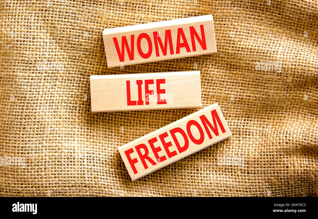 Woman life freedom symbol. Concept words Woman Life Freedom on wooden