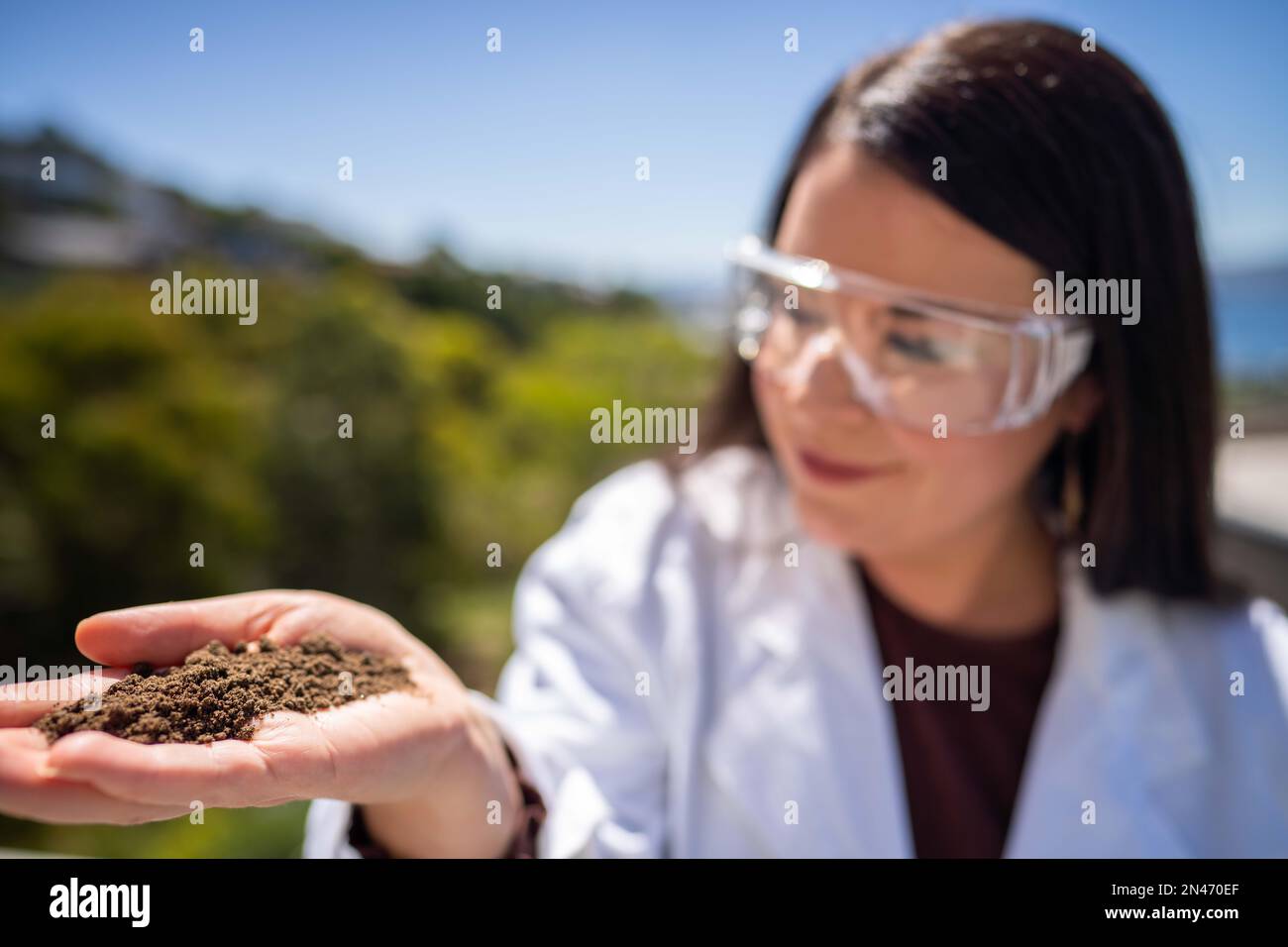 Soil test, female agricultural scientist conducting a soil test in a