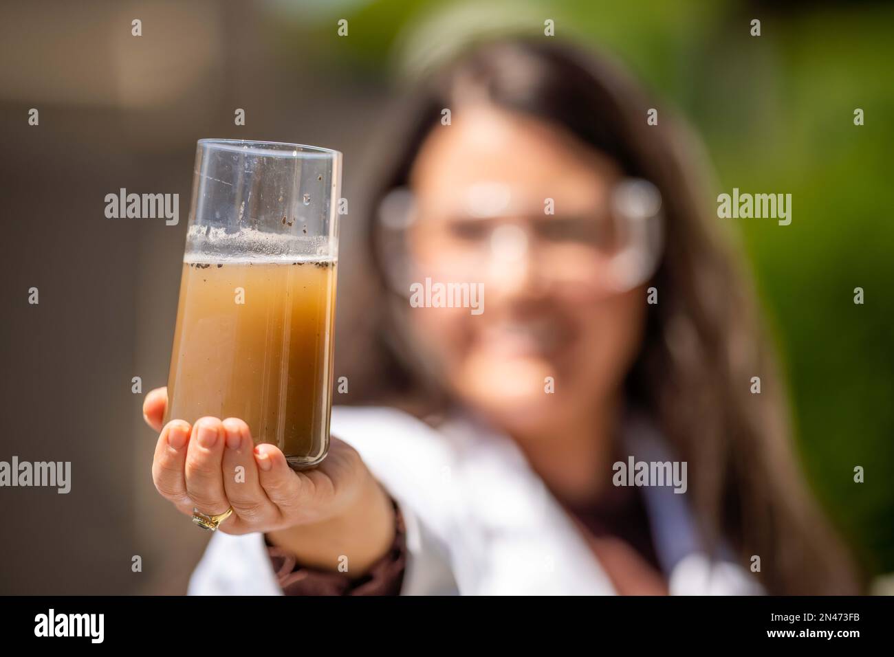 Soil test, female agricultural scientist conducting a soil test in a