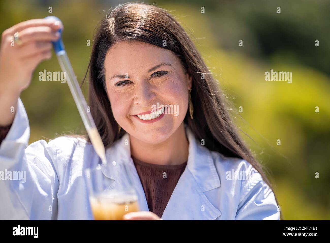 Soil test, female agricultural scientist conducting a soil test in a