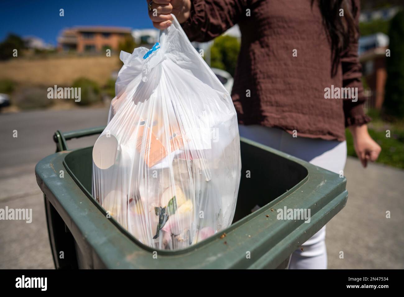 sorting recycling and rubbish in bins in hobart tasmania australia in