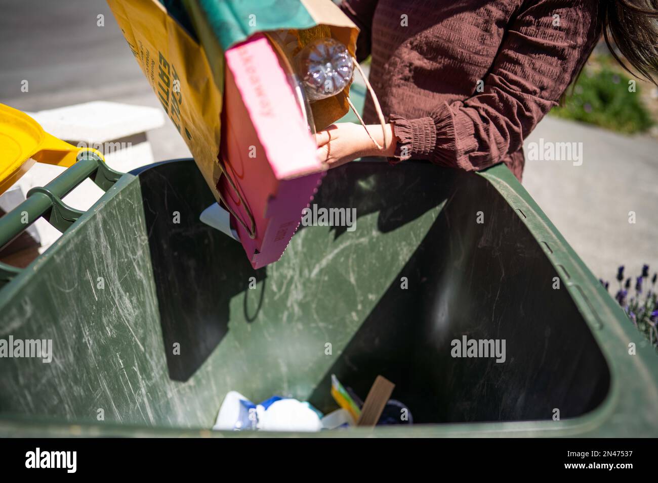 sorting recycling and rubbish in bins in hobart tasmania australia in